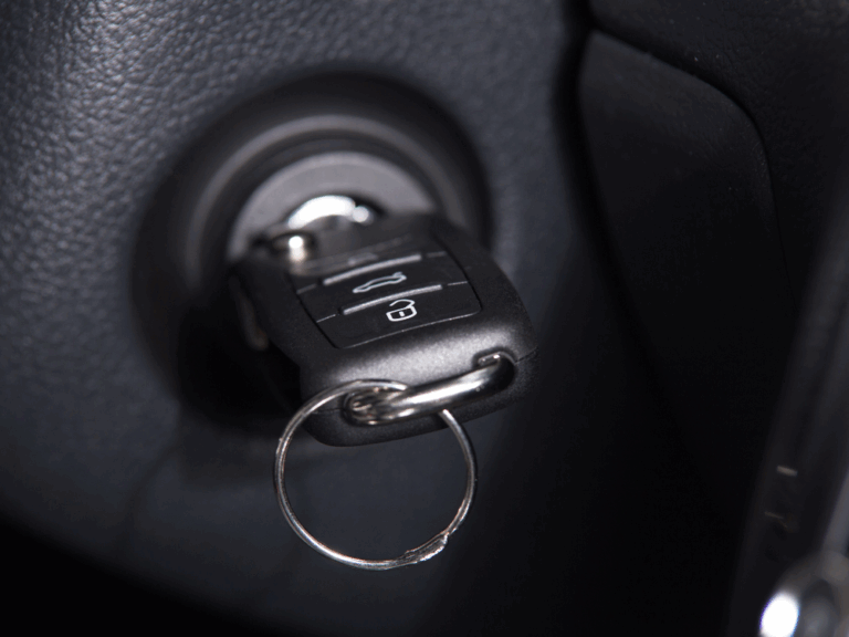 Technician using a key extractor to remove a broken key from a vehicle ignition.