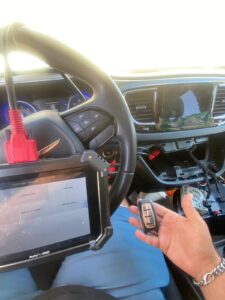 a Locksmith programming a car key